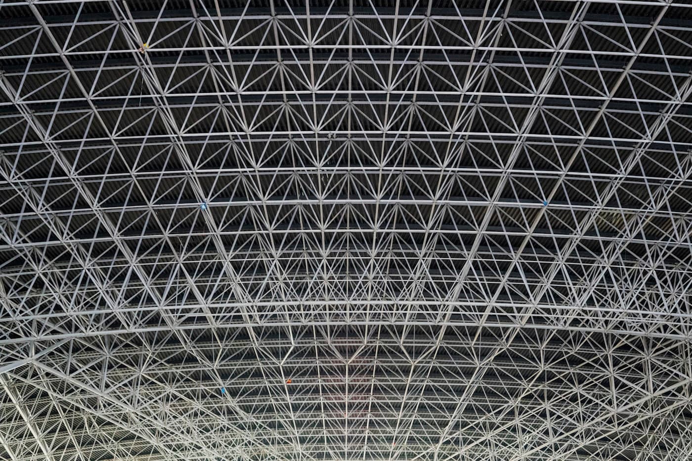A steel space frame — many small members carrying one load
